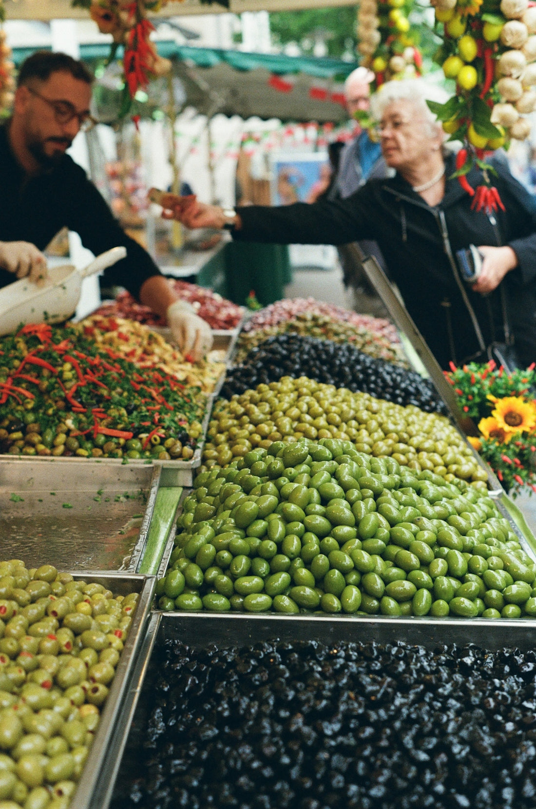 A group of people shopping for fruits and vegetables