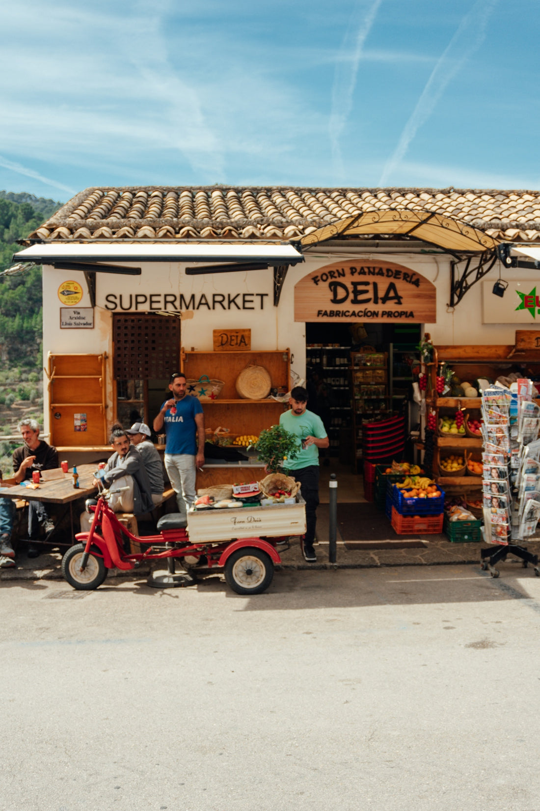 A charming spanish supermarket with customers outside.