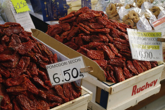 Dried tomatoes are displayed at a market.